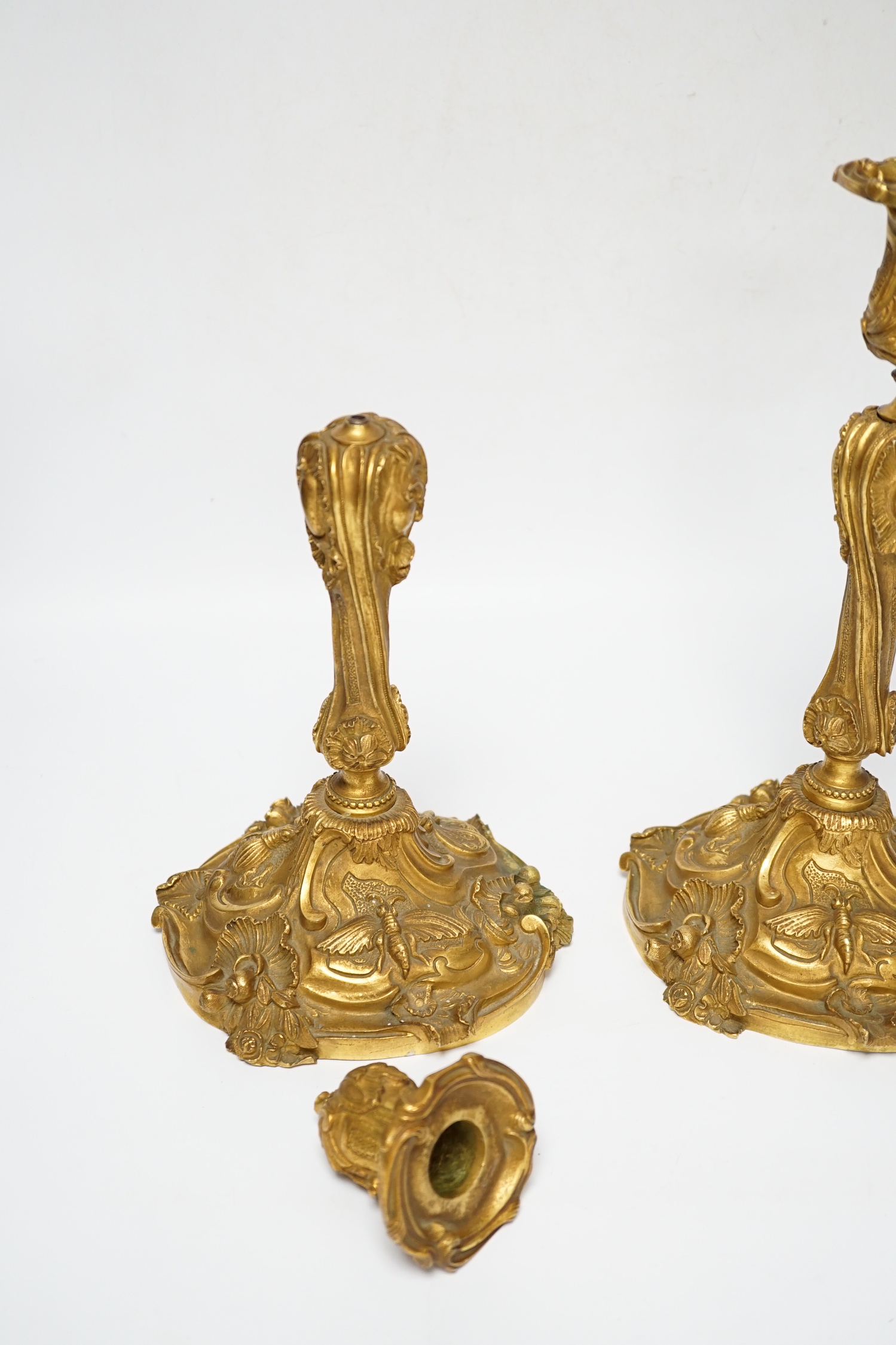 A pair of French ormolu candlesticks, one detached sconce, 30cm